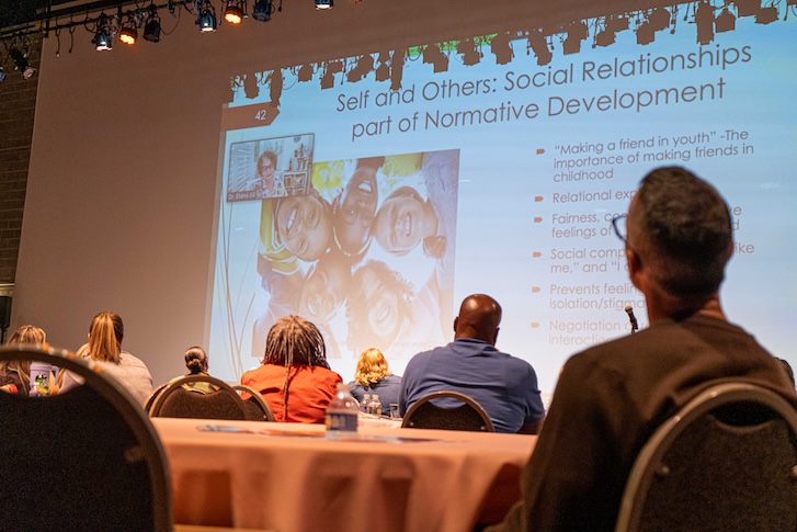 Audience looking at projector screen during presentation